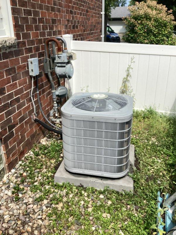 Diagnosed failed compressor on existing residential air conditioning system. Provided comprehensive replacement estimate for complete HVAC system including outdoor condensing unit and indoor air handler. Documented current equipment configuration showing outdoor unit installed on concrete pad with gravel surround, refrigerant line set running from exterior wall to condenser, and electrical disconnect properly mounted. Interior air handler inspection revealed vertical installation in mechanical closet with existing ductwork plenum, PVC condensate drain lines, and refrigerant piping connections. Photographed both components to support replacement proposal and ensure accurate equipment sizing for new system installation.