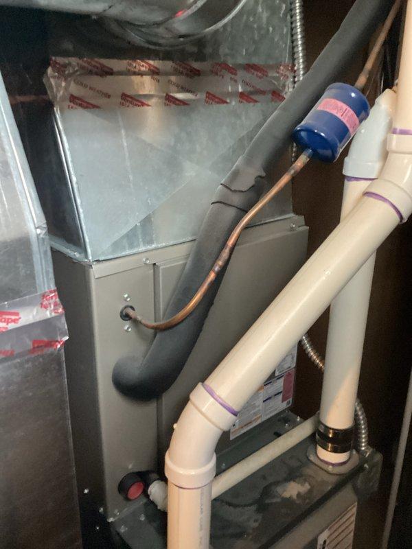 Diagnosed failed compressor on existing residential air conditioning system. Provided comprehensive replacement estimate for complete HVAC system including outdoor condensing unit and indoor air handler. Documented current equipment configuration showing outdoor unit installed on concrete pad with gravel surround, refrigerant line set running from exterior wall to condenser, and electrical disconnect properly mounted. Interior air handler inspection revealed vertical installation in mechanical closet with existing ductwork plenum, PVC condensate drain lines, and refrigerant piping connections. Photographed both components to support replacement proposal and ensure accurate equipment sizing for new system installation.