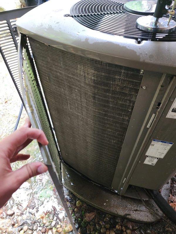 Completed routine AC maintenance on a 3-year-old air conditioning system located at the rear of the property. Inspection revealed significant dust and debris accumulation on the evaporator coil and internal surfaces of the air handler, as well as clogged condenser unit filters. Cleaned and serviced both indoor and outdoor components, removed filter panel for cleaning, and cleared debris from condenser grille to restore proper airflow and system efficiency.