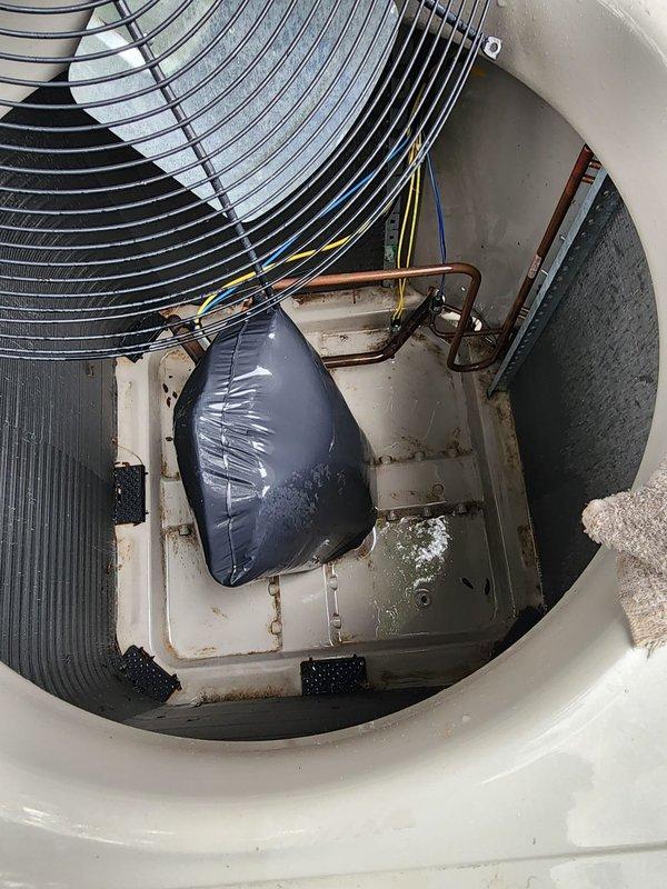 Performed comprehensive AC tune-up on 5-year-old outdoor condenser unit located at northwest corner of property. Conducted full system inspection including condenser coil examination, fan motor operation check, refrigerant line assessment, and electrical connection verification. Unit showed normal wear consistent with age, with minor debris accumulation and surface oxidation noted on internal components. Cleaned condenser coils, verified proper airflow through heat exchanger fins, and inspected compressor housing and mounting. All electrical wiring connections secure with no signs of degradation. Refrigerant lines intact with no visible leaks or damage. Fan motor operating smoothly with protective grille properly secured. System operational and performing within manufacturer specifications upon completion of maintenance service.