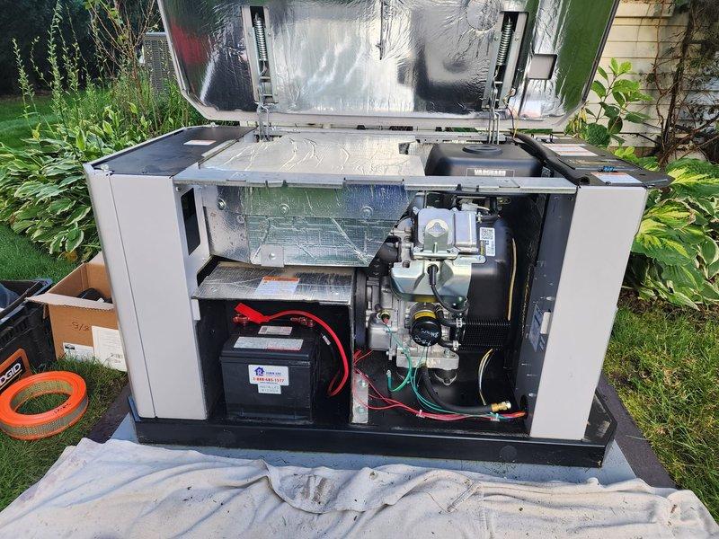 Performed routine preventive maintenance on residential backup generator system. Accessed internal components through top panel, inspected battery connections and electrical systems, and replaced spark plugs as part of scheduled maintenance protocol. All mechanical and electrical components verified operational, unit tested and secured upon completion.