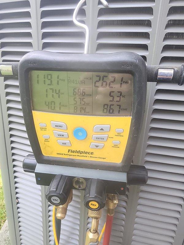 Completed comprehensive AC tune-up on approximately 15-year-old outdoor condensing unit. Performed system diagnostics using Fieldpiece SMAN manifold gauge, measuring refrigerant pressures and temperatures across the system to verify proper charge levels and operational parameters. Inspected condenser coils, fan operation, electrical connections, and refrigerant lines; noted unit operational with readings within acceptable range for ambient conditions.