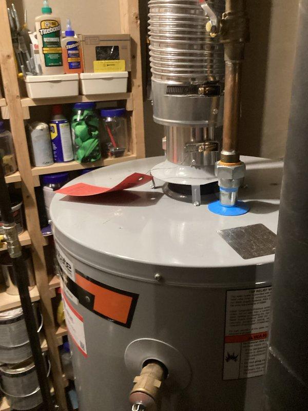 Performed water heater replacement estimate for an 8-year-old unit experiencing active leaking from the bottom tank seam. Documented existing installation configuration including venting system, supply lines, and utility room layout to provide accurate replacement specifications and labor requirements.