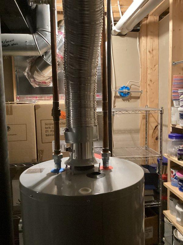 Performed water heater replacement estimate for an 8-year-old unit experiencing active leaking from the bottom tank seam. Documented existing installation configuration including venting system, supply lines, and utility room layout to provide accurate replacement specifications and labor requirements.