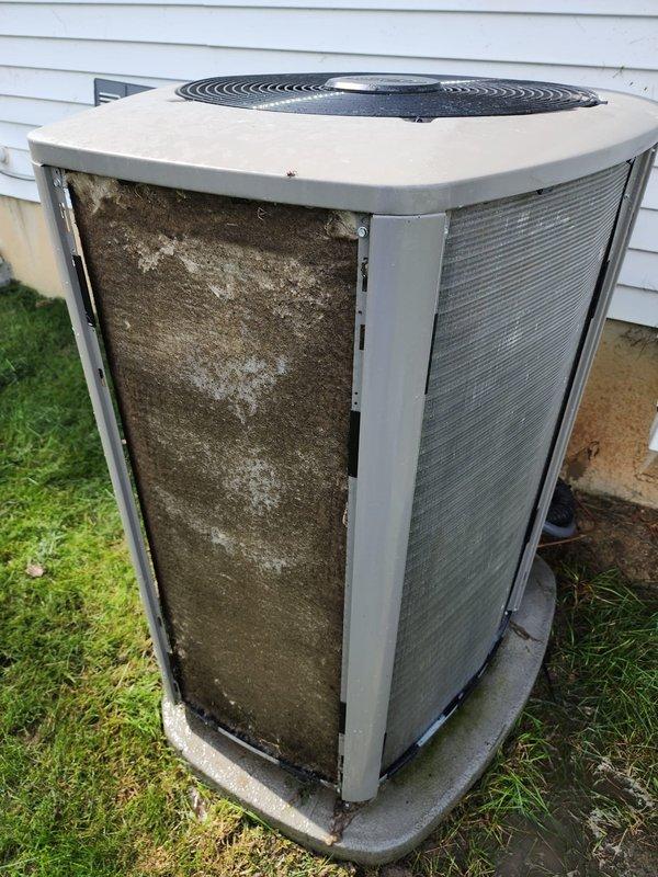 Completed comprehensive maintenance on residential split system air conditioning unit and furnace. Outdoor condenser unit exhibited severe airflow restriction due to extensive debris accumulation on coil surfaces and louver panels. Performed thorough cleaning of condenser coils, removed heavy buildup of dust, lint, and outdoor contaminants from all exterior panels and fins. Cleared obstructed airflow passages to restore proper system ventilation and heat exchange efficiency. Inspected fan assembly and motor operation. Replaced air filters on both AC and furnace systems. Conducted standard tune-up procedures including electrical connection inspection, refrigerant level verification, and overall system performance evaluation. Unit restored to optimal operating condition with significantly improved airflow capacity.