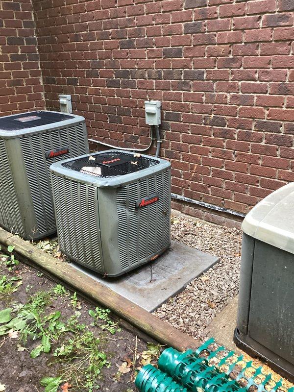 Completed comprehensive estimate for replacement of storm-damaged HVAC system and generator equipment. Assessed two Bryant condenser units positioned on exterior concrete pads against brick wall, along with Honeywell indoor air handling equipment located in basement utility area, all requiring replacement due to storm damage sustained on 9-11. Documented existing equipment configuration, electrical disconnects, and structural conditions through detailed photography to support replacement specifications and scope of work.