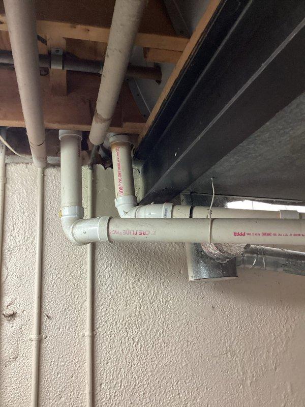 Conducted HVAC system evaluation for replacement estimate on aging equipment including an R22 air conditioning unit from 2014 experiencing low refrigerant levels and a furnace dating from 2002. Documented existing basement mechanical room configuration with photographs showing current equipment layout, including the aged furnace unit with visible wear on galvanized exterior, associated ductwork, and plumbing infrastructure. Assessed system compatibility and prepared comprehensive replacement recommendations for complete HVAC system upgrade.