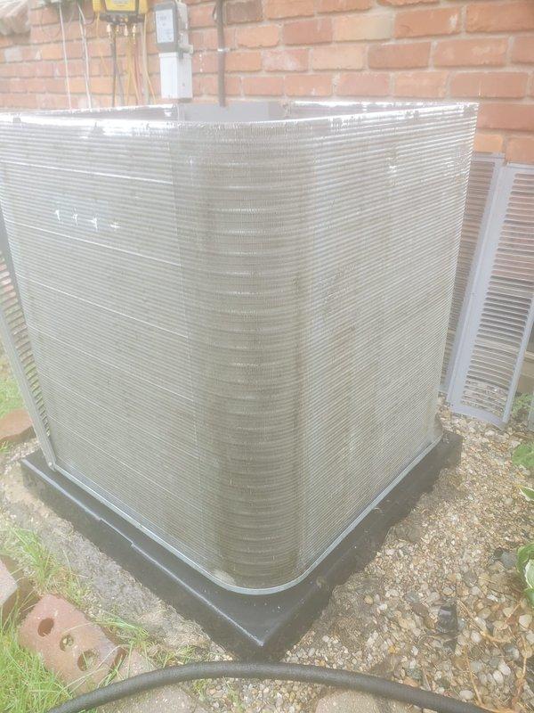 Performed routine maintenance on residential air conditioning system. Inspected outdoor condenser unit with visible dirt and debris accumulation on exterior fins, examined internal components including compressor, refrigerant lines, and heat exchanger coil, and documented system condition through photographic records for service history.