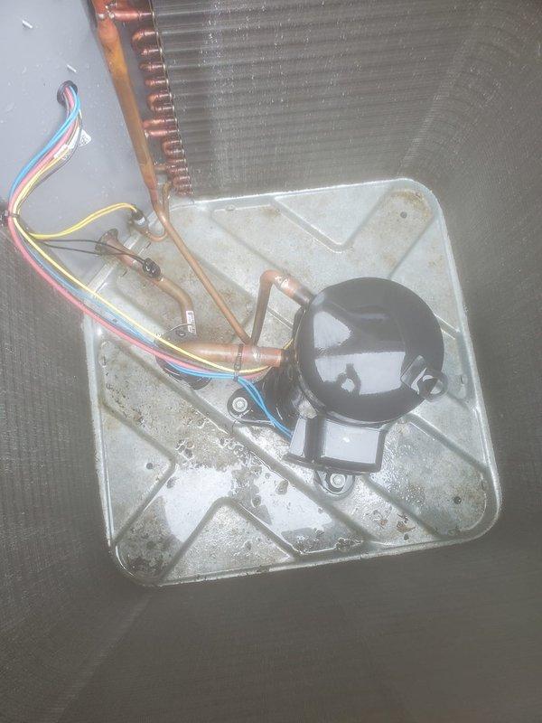 Performed routine maintenance on residential air conditioning system. Inspected outdoor condenser unit with visible dirt and debris accumulation on exterior fins, examined internal components including compressor, refrigerant lines, and heat exchanger coil, and documented system condition through photographic records for service history.