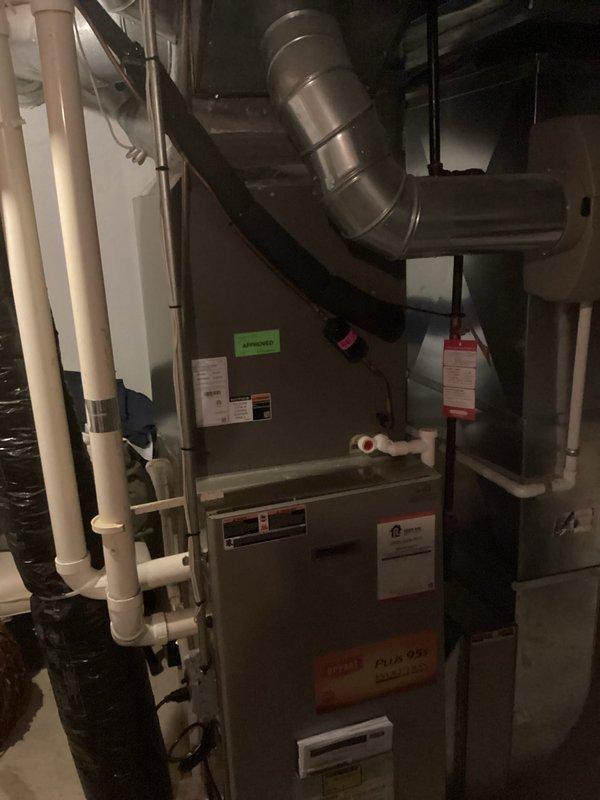 Completed comprehensive HVAC system replacement estimate for residential property. Assessed existing Bryant furnace installation in basement utility area, including evaluation of ductwork configuration, condensate drainage system with white PVC piping, and electrical service panel with dedicated circuit breakers. Documented current equipment specifications, manufacturer labels, and system components to provide accurate replacement recommendations for high-efficiency heating system upgrade.