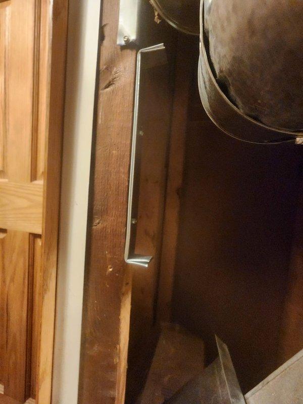 Responded to warranty inspection regarding furnace exhaust vent clearance violation at closet corner installation. Upon arrival, identified that the exhaust ductwork was installed too close to combustible door frame materials, with the clearance reduction method not meeting requirements specified in Section #308 of the 2021 Michigan Mechanical Code, which mandates a minimum 1" air space between metal ductwork and combustible materials, including proper spacing for metal stand-offs and mounting screws. Documented the code violation with photographs showing the improper mounting bracket installation on the wooden framing member and the insufficient clearance between the galvanized steel ductwork and adjacent door trim. Advised that corrective action is required to bring the installation into compliance with current mechanical code standards.