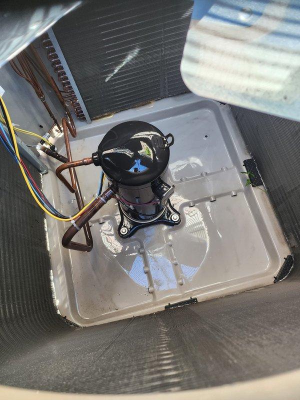 Completed comprehensive cooling season maintenance on residential air conditioning system. Performed thorough inspection of outdoor condenser unit, verified proper airflow through protective grille and coil fins, and examined compressor operation with associated copper refrigerant lines and electrical connections. Confirmed drain pan condition and documented system components in normal operating condition per Worry Free Service Agreement protocol.