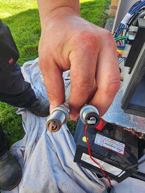 Performed scheduled preventive maintenance on residential Vanguard 627cc standby generator. Removed and inspected spark plugs, which showed normal wear patterns and carbon deposits consistent with regular operation. Verified all electrical connections, battery condition, and mounted components for proper operation. Unit tested successfully and returned to service with all systems functioning within normal parameters.