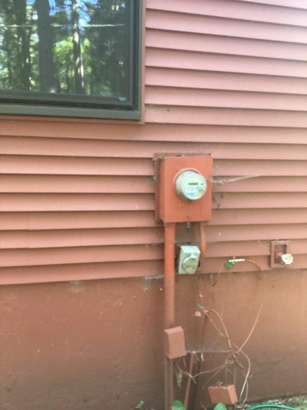 Conducted on-site electrical assessment for standby generator installation at residential property. Evaluated existing electrical service infrastructure, including current meter base and main service panel configuration. Documented exterior utility access points and determined optimal generator placement location considering clearance requirements, fuel line routing, and transfer switch installation parameters. Photographed existing electrical meter installation with orange service panel and conduit routing to assess compatibility with automatic transfer switch integration. Assessed site conditions including building exterior access, foundation clearances, and utility corridor for generator pad placement and electrical connections. Provided customer with comprehensive estimate range for complete generator system installation including unit specifications, transfer switch options, and necessary electrical modifications. Scheduled follow-up installation pending customer approval, accommo