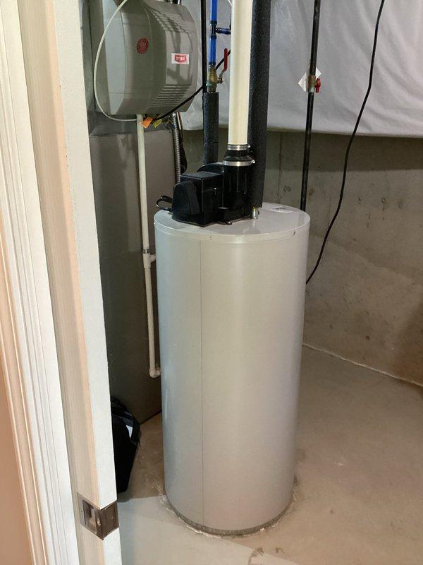 Conducted on-site assessment of existing Bradford White 50-gallon power vent water heater in basement utility area. Documented current equipment configuration, including venting system, gas connections, and proximity to existing water softener and HVAC equipment. Photographed installation area showing concrete block walls, exposed ceiling joists with existing plumbing and ductwork routing, and available clearances for replacement unit. Prepared comprehensive replacement estimate for new power vent water heater with comparable specifications.