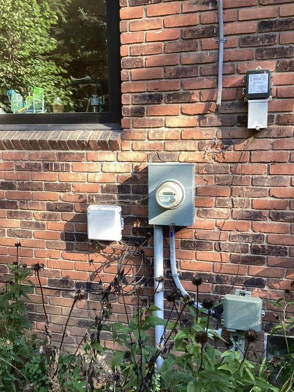 Conducted comprehensive site evaluation for standby generator installation at residential property. Assessed existing natural gas meter and electrical service panel to determine feasibility and requirements for generator integration. Documented current utility infrastructure including gas supply line specifications, electrical meter configuration, and available mounting locations on exterior brick wall. Evaluated conduit routing options and identified optimal placement for automatic transfer switch installation. Photographed existing conditions to support material specifications and installation planning for whole-house backup power system.