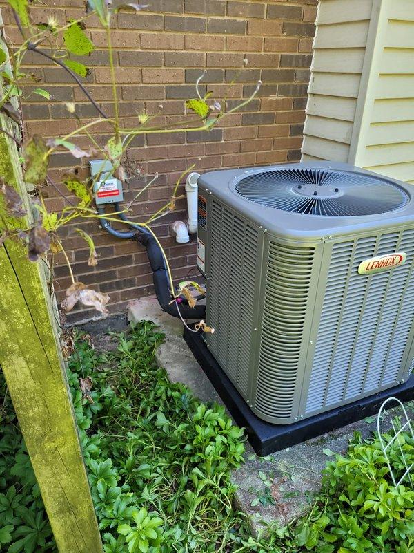 Completed full HVAC system installation including Lennox furnace, Lennox air conditioning condenser unit, Ecobee6 smart thermostat, and whole-home humidifier. The outdoor condenser was positioned on a concrete pad against the exterior brick wall with refrigerant lines and electrical connections properly routed and insulated. All equipment was installed to manufacturer specifications, system was charged, tested, and verified operational.