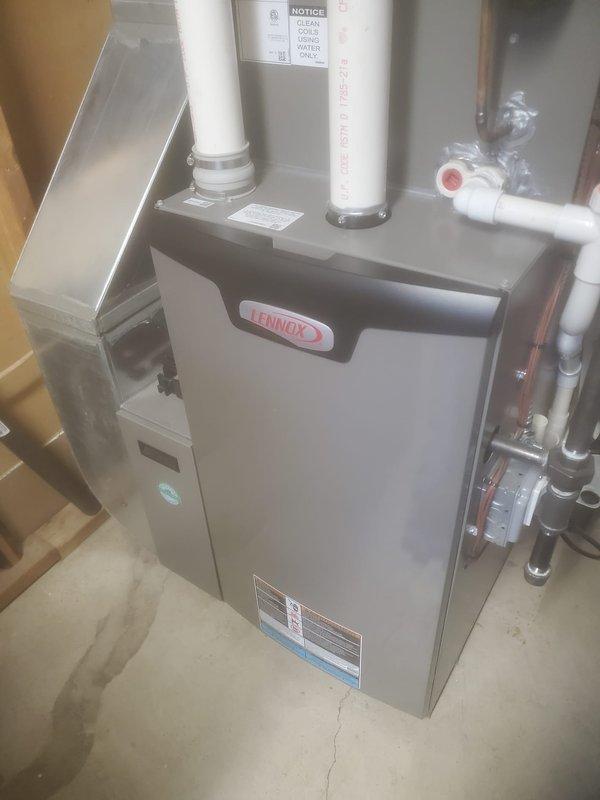 Completed Worry Free Service Agreement heating maintenance on Lennox furnace system. Performed comprehensive inspection of furnace cabinet, verified proper operation of all components, and inspected venting system with dual white PVC intake and exhaust pipes. Examined gas line connections, shut-off valves, and copper piping for leaks or issues. Inspected evaporator coil and identified frost/ice buildup on heat exchanger fins, indicating potential airflow restriction or refrigerant issue requiring attention. All safety controls, ductwork connections, and manufacturer specifications verified during maintenance visit.