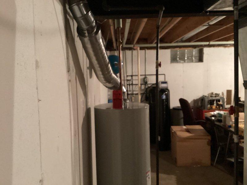 Completed full HVAC system replacement including installation of new Lennox furnace with associated ductwork, air conditioning unit, and Lennox T6 programmable thermostat for climate control. Installed 40-gallon residential water heater with proper venting and plumbing connections. Removed existing humidifier unit from system per customer request. All equipment installed in basement utility area with electrical connections, gas lines, condensate drainage, and refrigerant lines properly configured to manufacturer specifications. System tested and verified operational upon completion.
