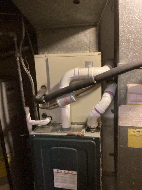 Completed on-site evaluation of non-operational central air conditioning system for full replacement estimate. Assessed existing outdoor condenser unit positioned on concrete pad against brick chimney and indoor air handler with associated ductwork, drainage lines, and heating components in mechanical closet. Documented current equipment configuration, installation conditions, and provided homeowner with comprehensive replacement options for complete HVAC system.