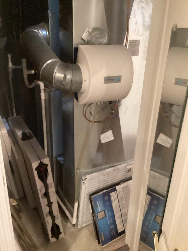 Provided comprehensive estimate for full HVAC system replacement of 22-year-old equipment currently located in basement utility area. Existing system includes natural gas furnace with air handler, humidifier unit, dual exhaust venting, and PVC condensate drainage, all components remain operational but have reached end of expected service life. Documented current installation configuration including ductwork connections, venting arrangement, and mechanical room layout to prepare accurate replacement specifications for comfort advisor consultation.