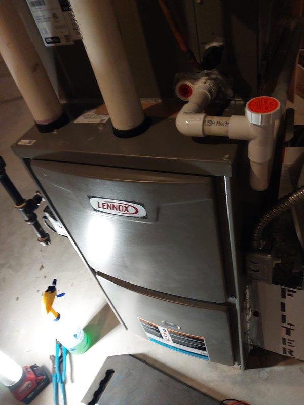 Completed annual maintenance tune-up on 5-year-old Lennox furnace located in basement. Performed comprehensive inspection of all system components including blower motor assembly, heat exchanger, burners, ignition system, and electrical controls. Verified proper operation of all safety switches, tested gas pressure, inspected flue and venting system including PVC condensate drain lines. Checked all electrical connections, control board functionality, and wiring harnesses. Examined blower motor and wheel, lubricated where applicable, and confirmed proper airflow. Inspected copper refrigerant lines and verified secure connections throughout cabinet. System operating within manufacturer specifications with no issues found. Unit left in excellent working condition.
