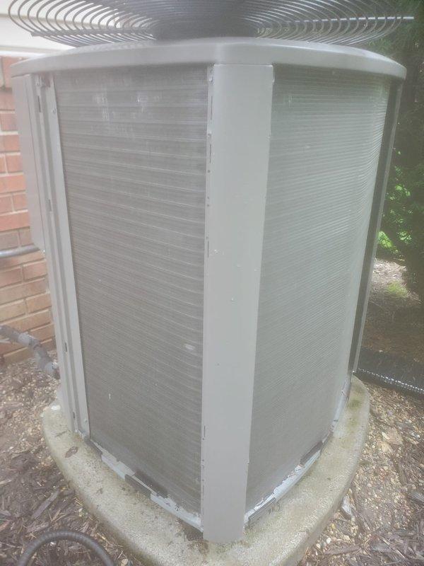 Completed preventive maintenance inspection on residential split-system air conditioning unit. Inspected indoor air handler assembly including condensate drain pan, which showed evidence of previous water accumulation with mineral deposits and staining but was functioning properly with condensate pump operational. Verified all drain line connections, float switch, and copper refrigerant lines for proper operation. Exterior condenser unit inspected on concrete pad, confirming fan guard secure, cabinet panels intact, and adequate clearance from structure maintained for proper airflow and heat dissipation.