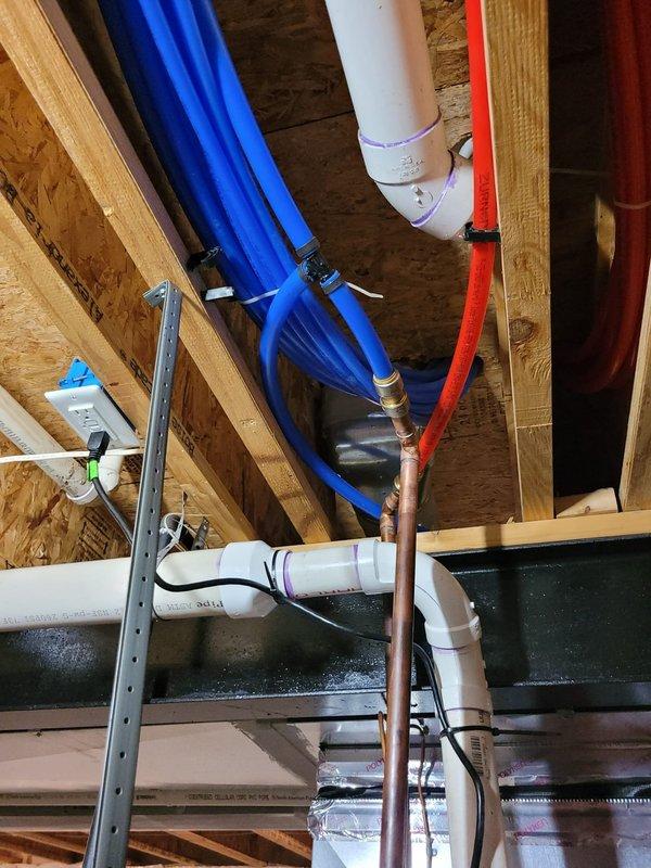 Successfully installed a 50-gallon tanked water heater in the basement utility area with all necessary connections and safety components. Replaced the defective pea fitting and installed a drain pan beneath the unit, properly plumbing the pan's discharge line into the existing drainage system to protect against potential leaks. All copper supply lines, brass fittings, and PVC drainage connections were secured according to code requirements, and the installation was tested for proper operation.