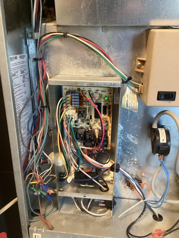 Conducted comprehensive HVAC system evaluation at mobile home residence to provide estimate for complete furnace and air conditioning replacement. Inspected existing Coleman packaged terminal unit installed in wall-mounted wooden cabinet enclosure, documenting current system configuration including electrical control board with blue relay, wire connections, and condensate management components. Currently operational system assessed for replacement specifications, with detailed photographic documentation of existing electrical connections, control box wiring, and through-wall installation parameters to ensure accurate equipment sizing and installation planning for new system.