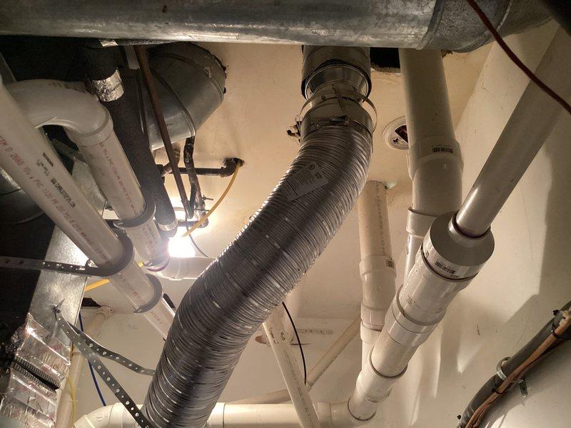 Completed installation of a 40-gallon Bradford White tanked water heater in residential utility space. Installation included proper venting with metallic flexible duct, connection of hot and cold water supply lines with copper piping, installation of expansion tank with appropriate fittings, and integration of necessary shut-off valves and pressure relief components. All plumbing connections were secured and tested for proper operation, with the unit fully operational upon completion.