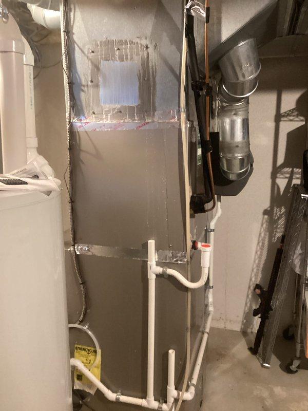 Performed comprehensive HVAC system evaluation for residential air conditioning unit experiencing low R-22 refrigerant levels. Assessed existing Bryant furnace and air handler installation in basement utility area, documenting current equipment condition including visible wear on metal casing and existing ductwork configuration with flexible and rigid metallic ducts. Evaluated condensate drainage system with white PVC piping and identified refrigerant deficiency requiring system replacement estimate due to obsolete R-22 refrigerant and equipment age. Provided replacement options for complete HVAC system upgrade to modern, energy-efficient equipment with environmentally compliant refrigerant.