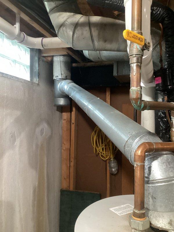 Responded to service call for leaking water heater. Upon inspection, found 25-year-old Bradford White Defender Safety System water heater showing signs of failure with active leak. Unit had exceeded its expected service life and was determined to be beyond economical repair. Documented existing installation including copper supply lines, gas control valve configuration, overhead plumbing connections, and proximity to HVAC equipment. Provided comprehensive estimate for complete water heater replacement, including removal of existing unit, installation of new water heater with proper venting, gas line connections, and code-compliant copper piping. Photographed current installation conditions and equipment specifications for replacement planning purposes.