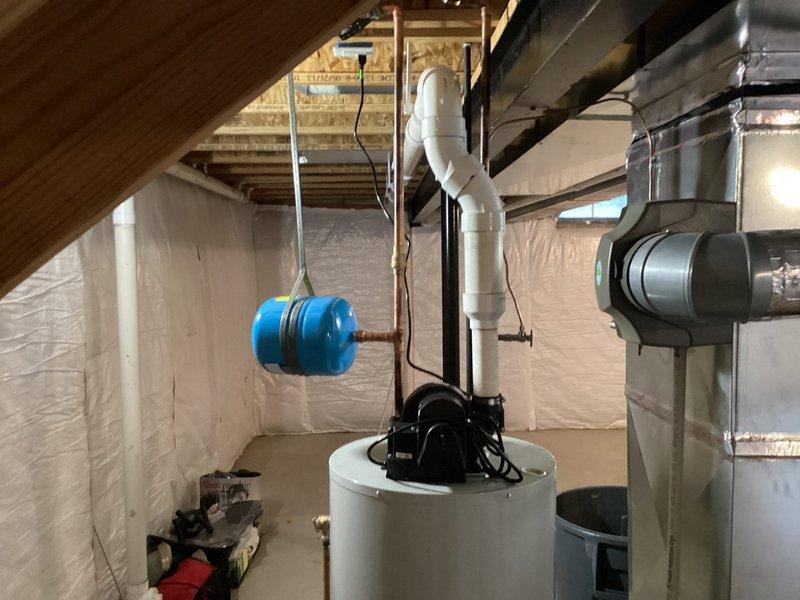 Returned to address leaking PEX connection at T-fitting near shark bite connection above water heater from previous installation. Replaced faulty PEX fitting with proper connection to eliminate slow leak. Completed installation of 50-gallon water heater with new drain pan and plumbed drain pan overflow line into existing drain system per code requirements.