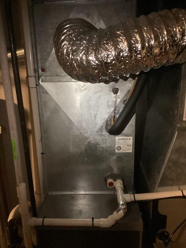 Conducted comprehensive HVAC system evaluation for aging equipment replacement estimate. Assessed existing air handler unit in basement installation, noting equipment age, overall condition, and operational status. Documented current system configuration including ductwork connections, condensate drain line assembly with PVC piping, and electrical service panel specifications to determine replacement requirements and compatibility for new equipment installation.