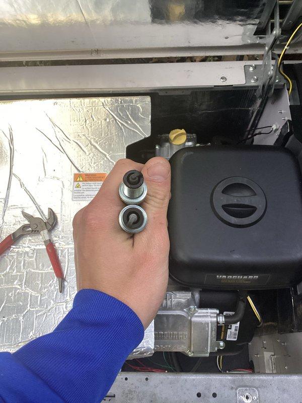 Performed routine maintenance on residential HVAC system, including inspection of internal components, gas valve assembly, and blower motor bearings. Technician accessed interior compartments, examined wiring connections and control units, and serviced mechanical components to ensure proper system operation.