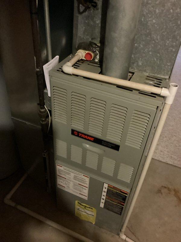 Conducted comprehensive evaluation of non-functional HVAC system with 30-year-old furnace and air conditioning unit, along with 13-year-old water heater. Identified failed AC disconnect box as immediate cause of air conditioning failure and assessed overall system condition for full replacement estimate. Documented existing Trane furnace installation, refrigerant line configuration, and venting system to provide accurate specifications for complete HVAC system and water heater replacement options.