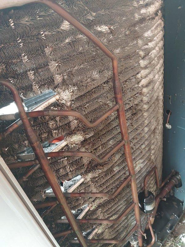 Completed preventive maintenance on residential air conditioning system under Worry Free Service Agreement. Inspected evaporator coil assembly and found significant accumulation of dust and debris on fin surfaces and copper refrigerant lines, which reduces heat transfer efficiency and system performance. Documented condition of coil assembly, copper piping, and mechanical components. Verified sump pump operation in condensate basin, confirming proper float switch function and drainage system performance to prevent water damage from HVAC condensate overflow.
