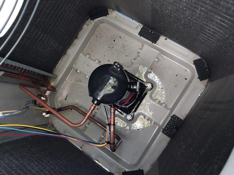 Completed preventive maintenance on residential air conditioning system. Inspected outdoor condenser unit, verified proper operation of condenser fan and protective grille assembly, and checked indoor air handler components. Examined condensate drain pan and pump assembly, confirmed proper drainage function with active condensation present, and noted normal moisture accumulation with minor mineral deposits on drain pan surface.
