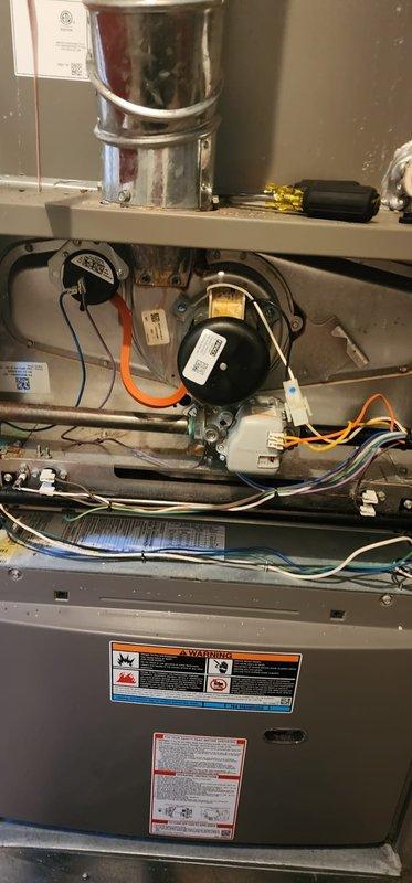 Completed comprehensive heating system maintenance inspection under Worry Free Service Agreement. Performed thorough examination of furnace interior components including blower motor, electrical connections, and wiring harnesses, confirming all systems operational with no deficiencies noted. Documented exterior condenser coil condition showing accumulated debris and recommended cleaning for optimal efficiency.