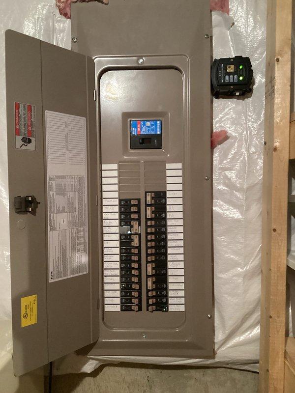 Installed whole home surge protection system at main electrical panel. Mounted surge protector device with digital monitoring display adjacent to service panel, establishing protection for all downstream circuits against voltage spikes and transient surges. Verified proper integration with existing electrical system, confirmed operational status through digital display indicators, and ensured all connections meet code requirements for surge suppression equipment installation.