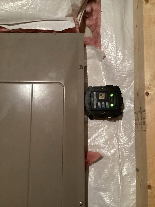 Installed whole home surge protection system at main electrical panel. Mounted surge protector device with digital monitoring display adjacent to service panel, establishing protection for all downstream circuits against voltage spikes and transient surges. Verified proper integration with existing electrical system, confirmed operational status through digital display indicators, and ensured all connections meet code requirements for surge suppression equipment installation.