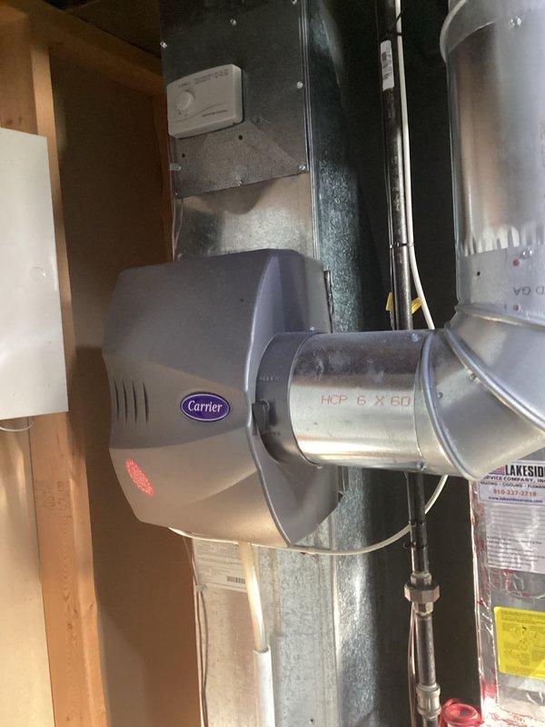 Conducted on-site evaluation for furnace replacement system. Assessed existing HVAC infrastructure including Carrier humidifier unit mounted on metallic ductwork and reviewed electrical panel configuration to determine compatibility requirements for new furnace installation. Documented current system components and electrical service capacity to prepare comprehensive replacement estimate.