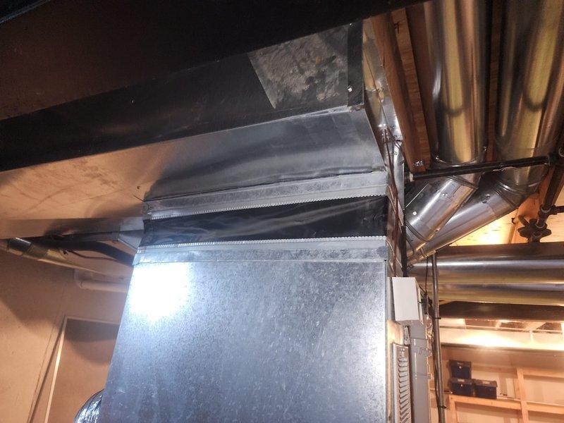 Responded to warranty callback for HVAC ductwork alignment issue. Upon arrival, inspected the canvas connector and rigid ductwork system that had been reported as misaligned and compressed. Corrected the flexible duct connection, ensuring proper alignment and eliminating compression points in the canvas transition. Adjusted mounting hardware and repositioned the metallic flex duct to maintain proper airflow clearances. Verified all duct connections were secure and properly sealed at joints. Documented the corrected installation with photographs showing the realigned ductwork, properly positioned flexible connections, and overall system configuration. Completed follow-up documentation as requested for re-inspection scheduling.