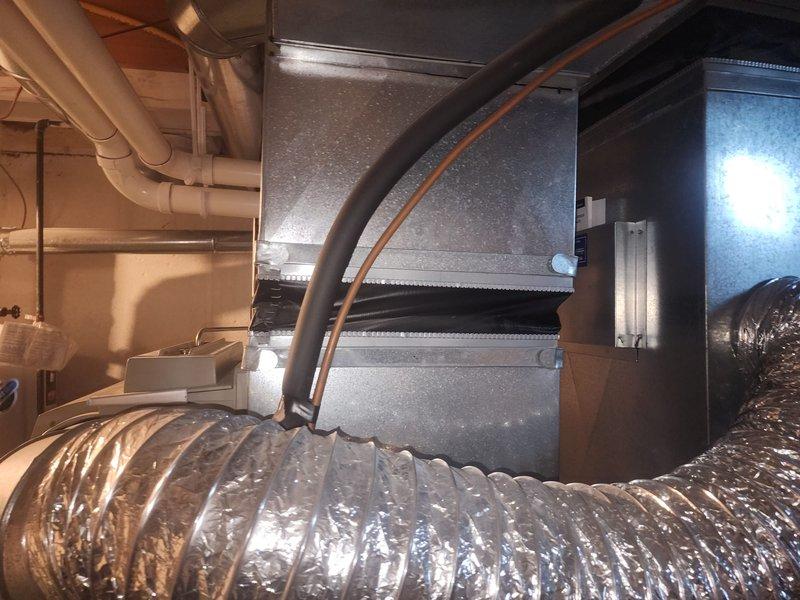 Responded to warranty callback for HVAC ductwork alignment issue. Upon arrival, inspected the canvas connector and rigid ductwork system that had been reported as misaligned and compressed. Corrected the flexible duct connection, ensuring proper alignment and eliminating compression points in the canvas transition. Adjusted mounting hardware and repositioned the metallic flex duct to maintain proper airflow clearances. Verified all duct connections were secure and properly sealed at joints. Documented the corrected installation with photographs showing the realigned ductwork, properly positioned flexible connections, and overall system configuration. Completed follow-up documentation as requested for re-inspection scheduling.