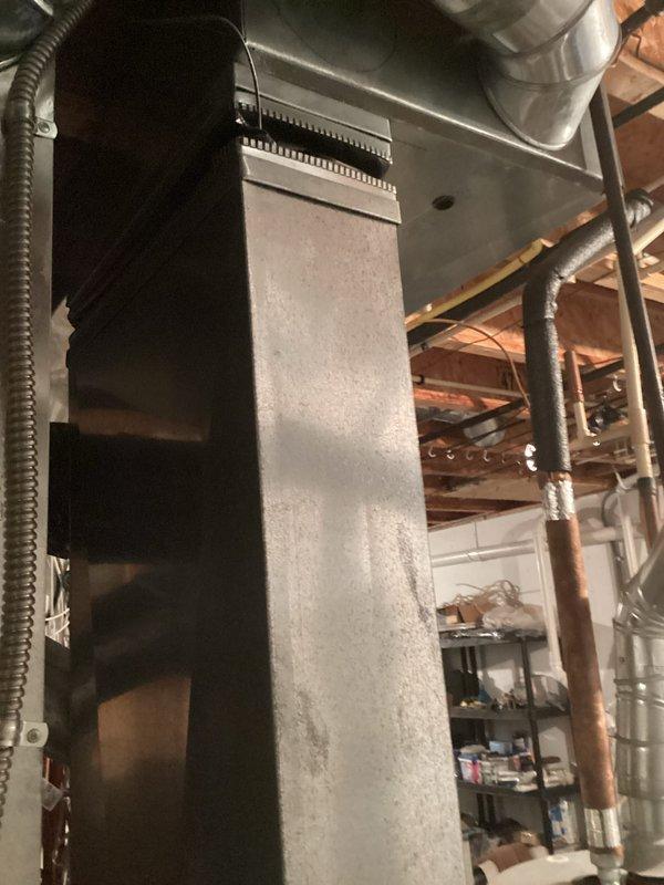 Provided estimate for replacement of 22-year-old furnace with failed heat exchanger. Unit is non-operational and located in basement utility area with existing electrical panel and ductwork infrastructure. Assessed current natural gas furnace installation, documented existing equipment configuration including vertical ductwork and electrical service for replacement specifications.