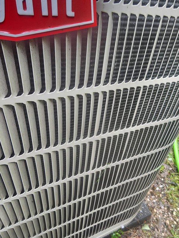 Completed scheduled AC maintenance inspection on residential cooling system. Inspected outdoor condenser unit and confirmed condenser coil fins are clean and undamaged with proper airflow clearance. Examined indoor evaporator coil assembly and drain pan, noting standing water present in condensate tray with visible copper refrigerant lines showing minor surface oxidation. Verified drain pan components and float switch are operational.