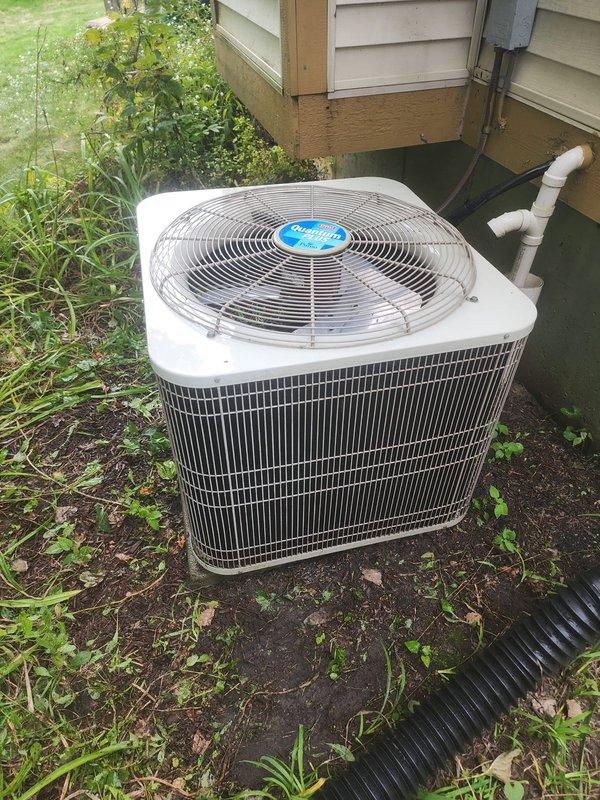Completed routine cooling season maintenance on residential air conditioning system per Worry Free Service Agreement. Performed comprehensive inspection of outdoor condenser unit and interior components, documenting system condition through photographs. Interior plenum showed accumulated dirt, dust, and debris buildup on metal surfaces with visible grime and streaking, indicating normal operational wear requiring monitoring. Outdoor condenser unit operating with fan assembly and protective guards intact, positioned on grade-level pad with refrigerant lines and drainage components present. System operational at time of service completion.