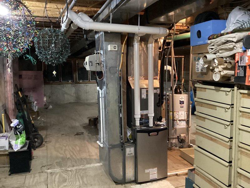 Completed full HVAC system installation in residential basement including new Lennox furnace with ductwork connections, two Lennox air conditioning units (left unit designated for upstairs zone), 50-gallon water heater, and S40 thermostat. Retained existing return air filter and humidifier per specifications, removed and disposed of old water heater from left side of mechanical area, and established all necessary piping, electrical connections, and condensate drainage systems. All equipment tested and operational upon completion.