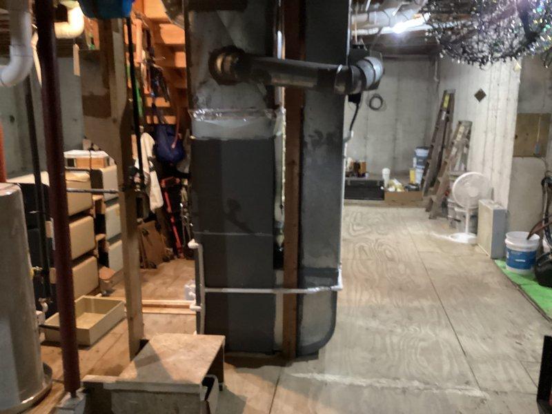 Completed full HVAC system installation in residential basement including new Lennox furnace with ductwork connections, two Lennox air conditioning units (left unit designated for upstairs zone), 50-gallon water heater, and S40 thermostat. Retained existing return air filter and humidifier per specifications, removed and disposed of old water heater from left side of mechanical area, and established all necessary piping, electrical connections, and condensate drainage systems. All equipment tested and operational upon completion.
