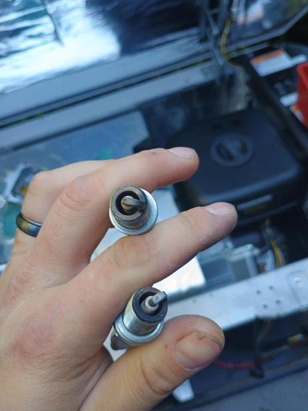 Completed routine maintenance on residential standby generator unit. Removed and inspected spark plugs, which showed normal wear patterns consistent with regular operation. Replaced spark plugs with new components to ensure reliable ignition and optimal engine performance. Verified generator unit operational status and confirmed all systems functioning properly.